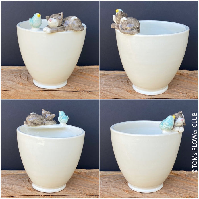 White, hand made, unique, ceramic plant pot without drain hole with one bird and sleeping cat on the pot top directly from the artist's work shop, offered for sale by TOMs FLOWer CLUB.
