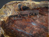 Reddish-brown petrified wood from Cherry Creek, Nevada, polished on both sides, 29 cm long, displayed with two wooden holders, for sale at TOMs FLOWer CLUB in Zurich, Switzerland.
