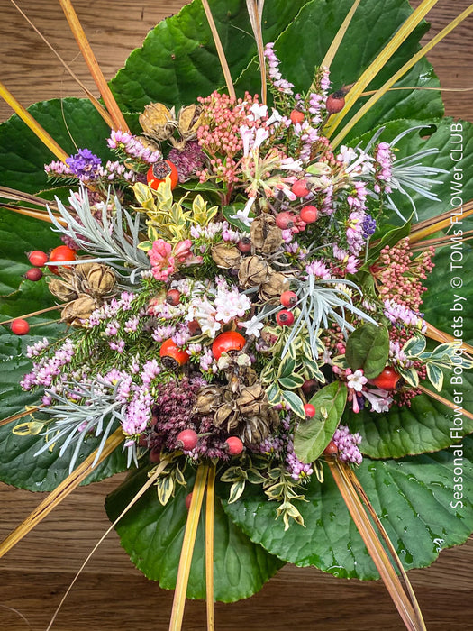 Seasonal winter flower bouquet with fresh flowers and winter foliage