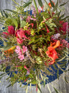 Exclusive fresh autumn flower arrangement in rich red, orange and earthy tones from TOMs FLOWer CLUB