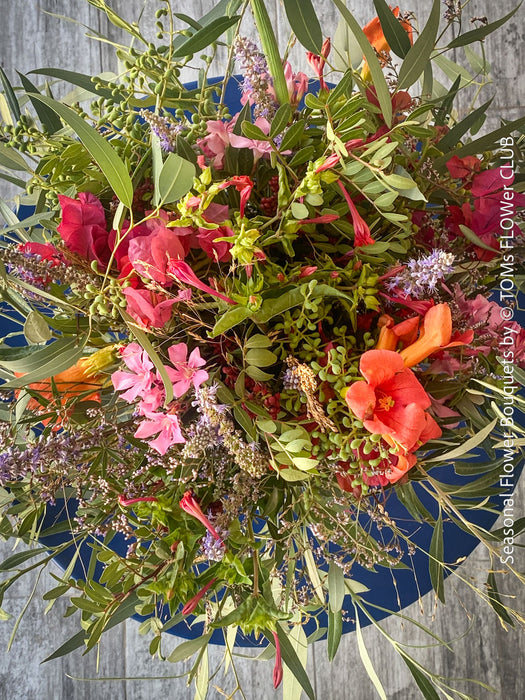 Exclusive fresh autumn flower arrangement in rich red, orange and earthy tones from TOMs FLOWer CLUB