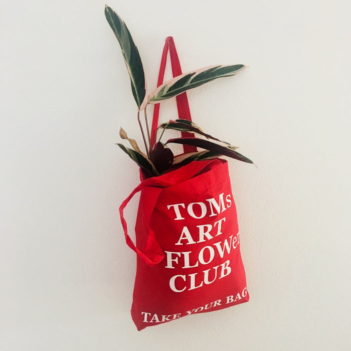 Red TAKE YOUR BAG with white TOMs ART FLOWer CLUB design by TOMs FLOWer CLUB made of 100% organic cotton, EarthPositive® certified, various colours, Swiss designed, premium quality, world wide shipping.