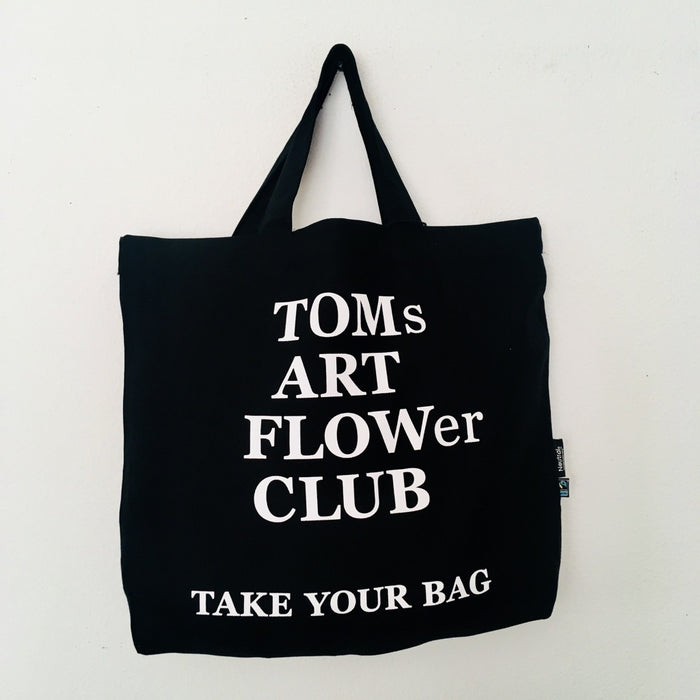 Black TAKE YOUR BAG with white TOMS FLOWer CLUB design made of 100% organic cotton, NEUTRAL® and FAIRTRADE® certified.