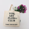 Beige TAKE YOUR BAG with black TOMsFLOWer ART FLOWer design made of 100% organic cotton, NEUTRAL® and FAIRTRADE® certified with ill flowers.