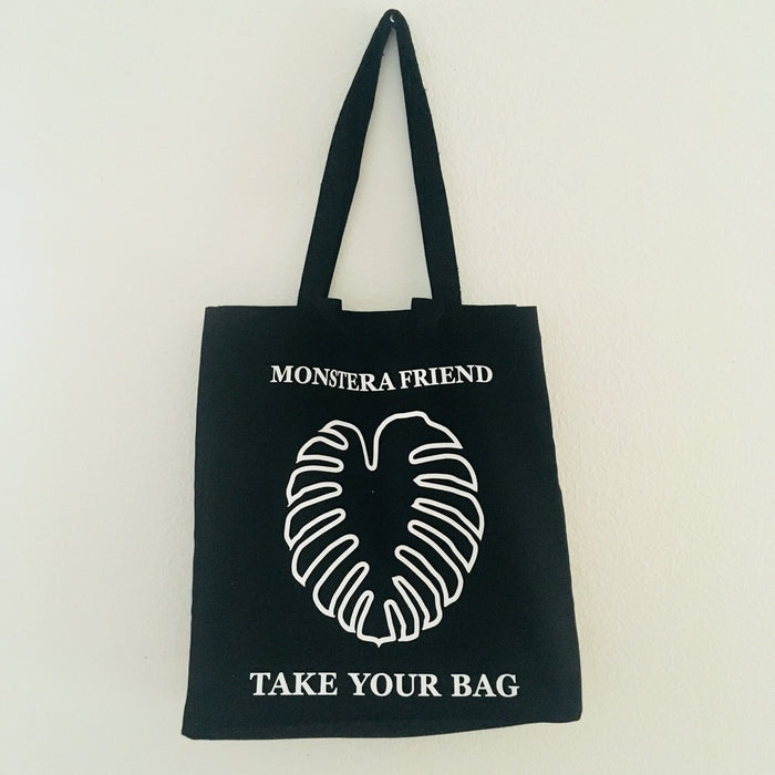 Monstera, Monstera delicious, Swiss cheese plant, Black TAKE YOUR BAG made of 100% organic cotton, NEUTRAL® and FAIRTRADE® certified with white MONSTERA FRIEND design.