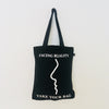 Black TAKE YOUR BAG with white FACING REALITY design by TOMs FLOWer CLUB made of 100% organic cotton, EarthPositive® certified, various colours, Swiss designed, premium quality, world wide shipping.