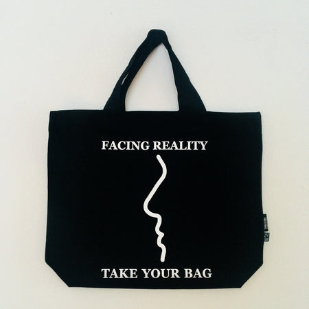 Black TAKE YOUR BAG with white FACING REALITY design made of 100% organic cotton, NEUTRAL® and FAIRTRADE® certified.