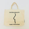 Beige TAKE YOUR BAG with black FACING REALITY design made of 100% organic cotton, NEUTRAL® and FAIRTRADE® certified.