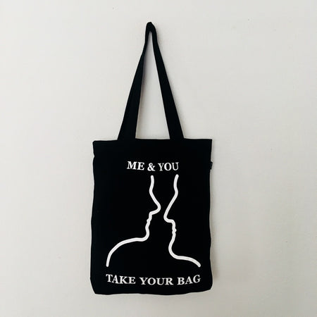 Black TAKE YOUR BAG with white ME & YOU design by TOMs FLOWer CLUB made of 100% organic cotton, EarthPositive® certified, various colours, Swiss designed, premium quality, world wide shipping.