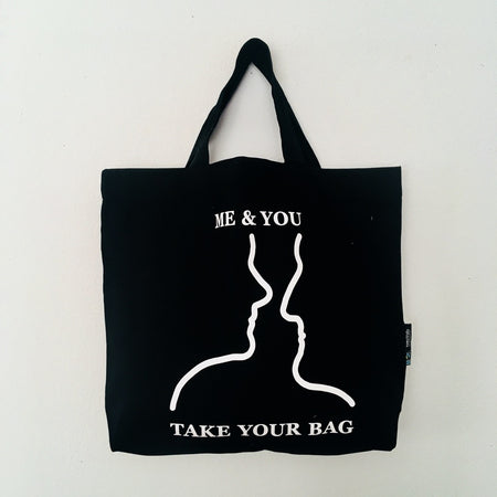 Black TAKE YOUR BAG with white ME & YOU design made of 100% organic cotton, NEUTRAL® and FAIRTRADE® certified.