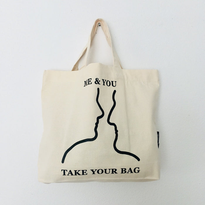Beige TAKE YOUR BAG with black ME & YOU design made of 100% organic cotton, NEUTRAL® and FAIRTRADE® certified.