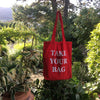Red TAKE YOUR BAG with white design by TOMs FLOWer CLUB made of 100% organic cotton, EarthPositive® certified, various colours, Swiss designed, premium quality, world wide shipping.
