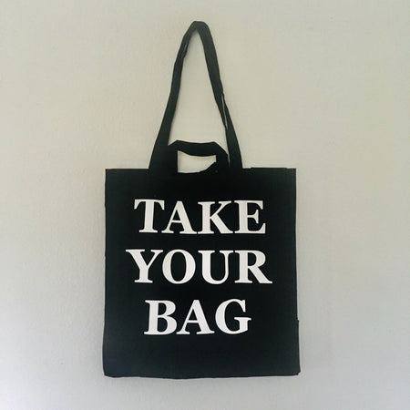 Black TAKE YOUR BAG made of 100% organic cotton, NEUTRAL® and FAIRTRADE® certified with white print design