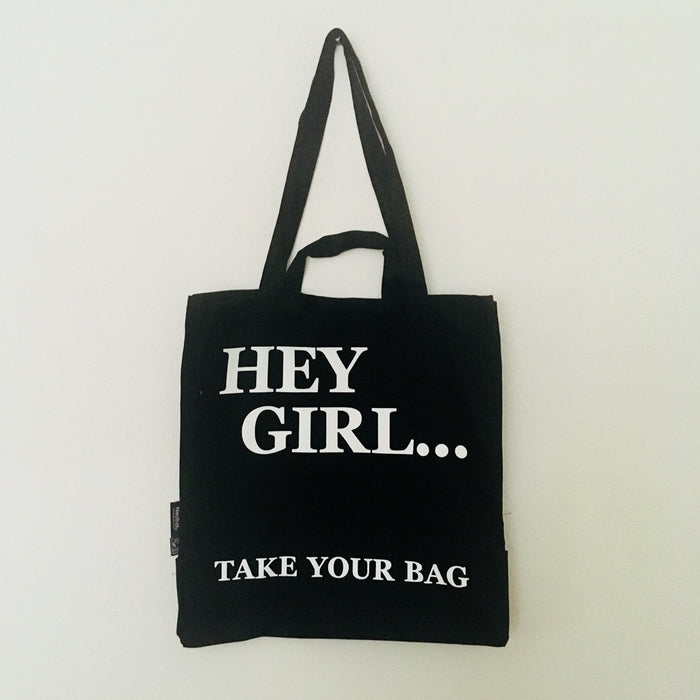 Black TAKE YOUR BAG made of 100% organic cotton, NEUTRAL® and FAIRTRADE® certified with white HEY GIRL design.