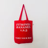 Red TAKE YOUR BAG with white ZITRONEN, BANANEN, 1,2,3 design by TOMs FLOWer CLUB made of 100% organic cotton, EarthPositive® certified, various colours, Swiss designed, premium quality, world wide shipping.