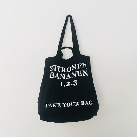 Black TAKE YOUR BAG made of 100% organic cotton, NEUTRAL® and FAIRTRADE® certified with white ZITRONEN, BANANEN, 1, 2, 3 design