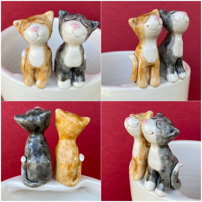Ceramic plant pot with two cats