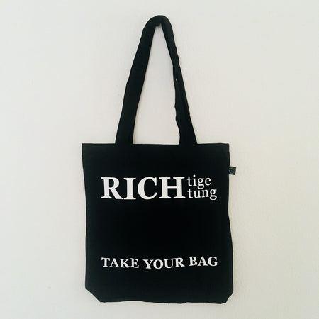 Black TAKE YOUR BAG with white RICH design by TOMs FLOWer CLUB made of 100% organic cotton, EarthPositive® certified, various colours, Swiss designed, premium quality, world wide shipping.