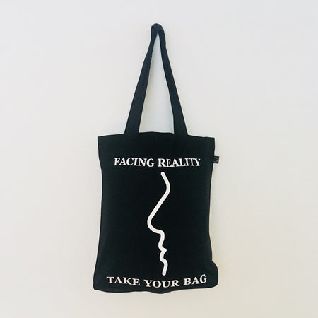 Black TAKE YOUR BAG with white FACING REALITY design by TOMs FLOWer CLUB made of 100% organic cotton, EarthPositive® certified, various colours, Swiss designed, premium quality, world wide shipping.
