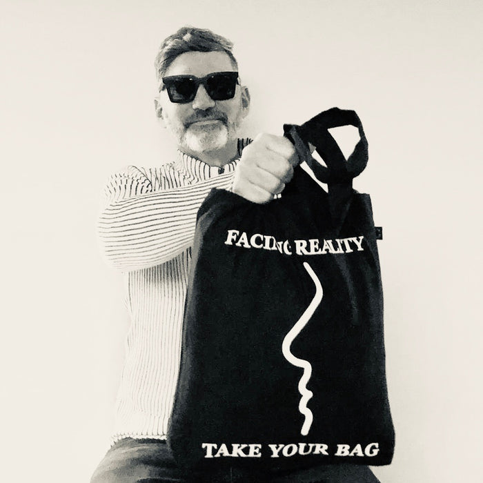 Black TAKE YOUR BAG with white FACING REALITY design by TOMs FLOWer CLUB made of 100% organic cotton, EarthPositive® certified, various colours, Swiss designed, premium quality, world wide shipping.