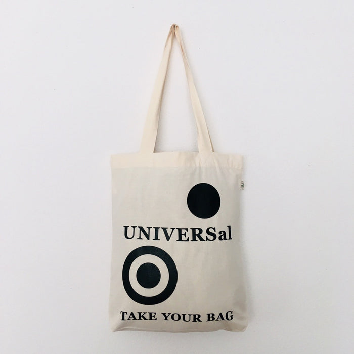A beige cotton tote bag with a black circular logo and the text 'UNIVERSal' on it, with a small black circle and the text 'TAKE YOUR BAG' below it.