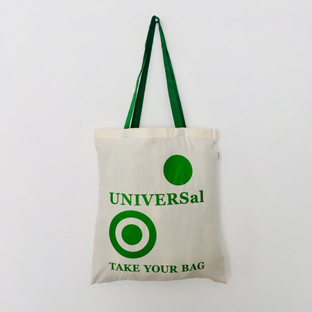 A beige cotton tote bag with a green handle, featuring the text 'UNIVERSal' and 'TAKE YOUR BAG' printed on the front.