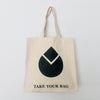 A beige cotton canvas bag with a black water drop design and the text 'TAKE YOUR BAG' on the bottom.