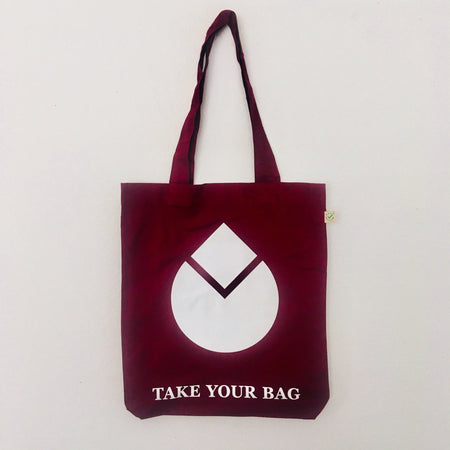 A burgundy tote bag with a white water drop design and text 'TAKE YOUR BAG' on the bottom.