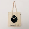 A beige canvas tote bag with a black water drop design and the text 'TAKE YOUR BAG' printed on the front.