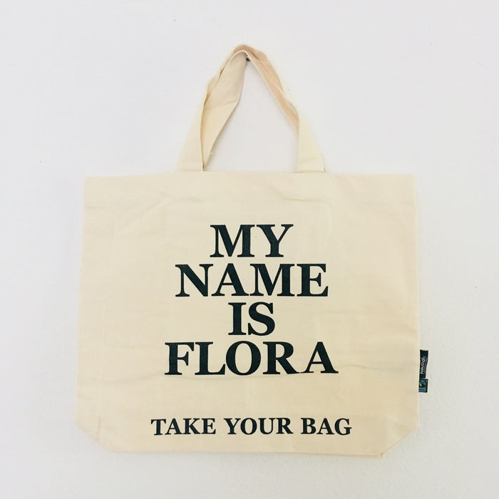 Beige TAKE YOUR BAG with black MY NAME IS FLORA design made of 100% organic cotton, NEUTRAL® and FAIRTRADE® certified.